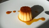 Decadent creme caramel dessert glistening with rich caramel sauce on a clean white plate