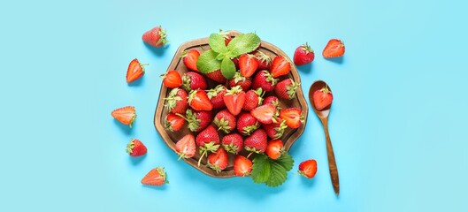 Wall Mural - wooden board and sweet strawberries on light blue background, top view