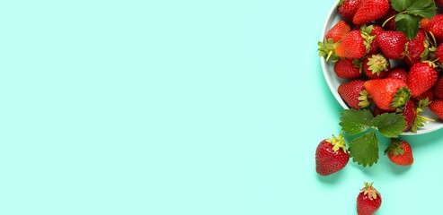Wall Mural - plate of fresh ripe strawberries on turquoise background with space for text, top view