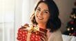© noval - Happy woman holding red Christmas gift