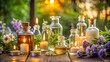 © Creative_johirul - Bottles of essential oil with candles and flowers in a garden setting