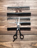 Professional hair styling tools arranged on a wooden surface