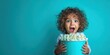 © Alkal - The joyful child holding a large bowl of popcorn with excitement