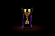 © Siyam - A golden trophy with purple ribbons on a black pedestal against a dark black background studio shot