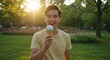 © Anzhelika - Caucasian man enjoying ice cream with a happy expression in a sunny park. Summer dessert concept for outdoor activities.