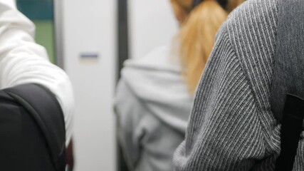 Canvas Print - selective focusing pov to rear back view of passenger while waiting to get out of the train subway commuter while train arriving to platform station,passenger crowded on public train transportation