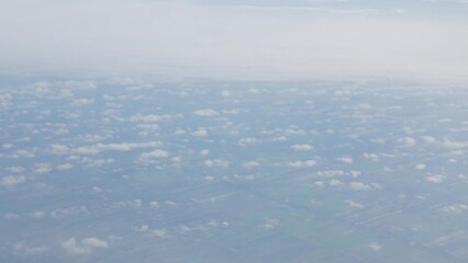 Wall Mural - Aerial view above the clouds and sky inspiration concept in cinematic breathtaking aerial flying over white fluffy cloudscape in high altitude sky with fresh clean air and blue skies on background.
