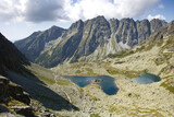 Mountain landscape. European mountains Tatras mountains. Mountains tops in the clouds, blue sky. The Tatra Mountains. The tops of the mountain and lakes below.