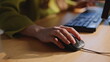 © stockbusters - Finger moving computer mouse keyboard workstation closeup. Businesswoman texting