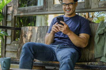 man using mobile phone holding cell phone texting message contact us.chatting,search internet shopping online.device communication connecting
