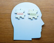 © izzuan - A human head-shaped cutout with puzzle pieces labeled 'FIXED MINDSET' and 'GROWTH MINDSET'. Psychological and different ways of thinking concept.