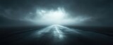 A serene, moody landscape featuring a dark road disappearing into mist and clouds, conveying a sense of mystery and exploration.
