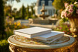 © Dzmitry - Blank white books placed on ornate table in a blooming garden setting