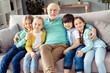 © deagreez - Photo of happy positive smiling good mood family grandfather hug embrace his grandchildren boys and girls at home