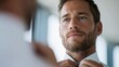 © Marina - Confident man adjusting tie in bright, modern environment showca