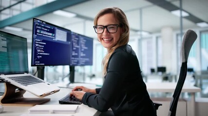 Happy Female Programmer Working On Multiple Screens