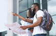 © Prostock-studio - That Way. Black Couple Of Travellers Checking Route On Their City Map While Standing Near Airport After Arrival