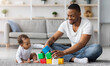 © Prostock-studio - Happy Young Black Father Playing With His Little Infant Baby Son At Home, African American Dad And His Cute Toddler Male Child Stacking Building Blocks While Sitting Together On Floor In Living Room