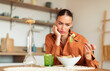 © Prostock-studio - Sad young caucasian lady looking at her caesar salad and dont want to eat, sitting at kitchen interior at table, free space. Lack of appetite, mood swings