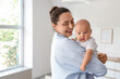 © Pixel-Shot - Beautiful young happy mother with her cute little baby at home