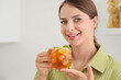 © Pixel-Shot - Beautiful young happy woman with cup of tasty cold tea in kitchen