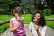 © Alan - Mother and daughter blowing dandelion seeds outdoors, smiling in nature. Concept of family love, childhood joy, playful parent child connection, happiness, carefree moment, outdoor leisure together