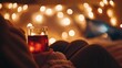 © Fikri - Cozy evening scene with person relaxing in bed with drink and bokeh lights background atmosphere