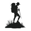 © MDHABIBUR - Silhouette of hiker with backpack and walking stick on grassy rock