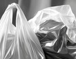 © Rasyid - Close-up of two plastic shopping bags, one light, one dark, with folds and textures