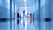© Echo - Blurred long hallway with figures, showcasing cool blues, reflections, and a sense of motion. Empty, clinical space suggests a hospital or office