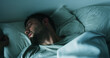 © peopleimages.com - Tired, man and sleeping on bed at house with nightmare, depression and mental exhaustion. Fatigue, male person and restless with insomnia, bad dream and fear for trauma ptsd with withdrawal symptoms