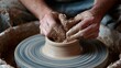 © Skoles - Creating a unique pottery piece on a spinning wheel with skilled hands crafting the clay in an artisan studio setting during the day