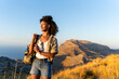 © Martí Rosselló - Young female traveler looking at the horizon during golden hour in Sierra de Tramuntana, Majorca, with copy space. Concept of adventure, nature and freedom.