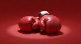 Red boxing gloves pair on vivid background