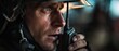 © Fernando - Focused Caucasian man firefighter in helmet using walkie talkie during emergency response Closeup portrait of determined fireman communicating during rescue operation Concept of bravery and service