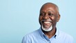 © Dandra - Smiling senior man against light blue backdrop