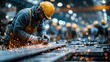 © Vitalii - Factory worker wearing helmet using grinder with sparks