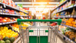 © Gunawan - First-person view of a shopping trolley in a modern supermarket aisle with a wide selection of food products