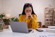 © David - Portrait of a Worried young asian woman using laptop computer at home, Sad, unhappy, Worried, Depression, or employee life stress concept