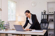 © David - Stylish smiling face happy asian business woman manager working on laptop while sitting in office. financial report, business plan investment, finance analysis concept. High quality photo