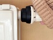 © Anastasiia Bublyk - Woman's hand in warm sweater unscrews radiator valve to turn on heating. Cold weather, beginning of heating season, regulating room temperature, warmth and comfort at home concept