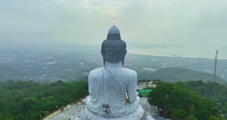 Wall Mural - aerial view Phuket Big Buddha is one of the island most 
important and revered landmarks on hill top of Phuket island.
aerial view Mist blows over the Phuket Big Buddha in colorful sunrise
