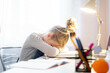 © Maria - Relaxing. Pretty little girl sleeping over her books while sitting at the table and doing homework