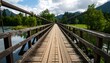 © Gam - Scenic wooden bridge over a river surrounded by nature