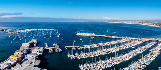 Wall Mural - panoramic drone view of Monterey Bay, California with wharf and boats in marina