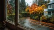 © GAN - View from inside cozy home looking out window onto rainy autumn day, window frame provides natural framing. Moody, reflective, copy space.