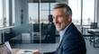 © Hanh - Confident Laughter of a Mature Executive in a Luminous Contemporary Workspace