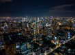 Aerial view of illuminated Bangkok city skyline and traffic at night, Thailand