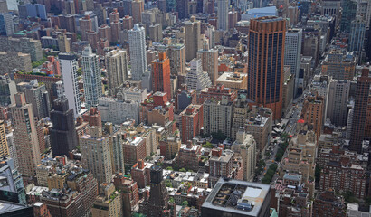  high angle view of the highly urbanized area of Midtown Manhattan in New York with skyscrapers and streets and cars