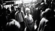© utaem2022 - Young woman standing still in busy blurred crowd